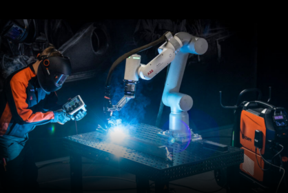 In the photo you can see ABB cobot having a Kemppi Flexlite MIG/MAG welding torch and welding. A human welder is watching it closely.