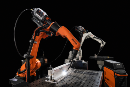 In this photo you can sii a welding robot with Kemppi AX MIGT Welder welding stainless steel on a welding table.